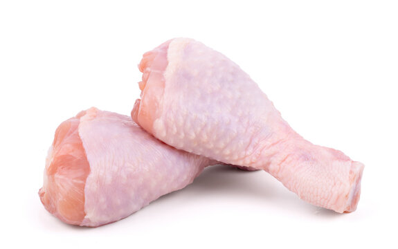 Two raw chicken drumsticks isolated on white background
