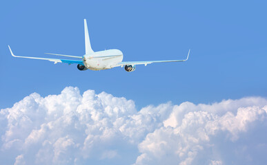 White passenger airplane over the clouds  - Travel by air transport
