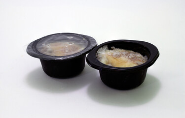 Frozen convenience foods from the supermarket. Chicken, mushroom and cheese julienne. Sealed plastic packaging for long-term storage in a refrigerator. Fast food market.