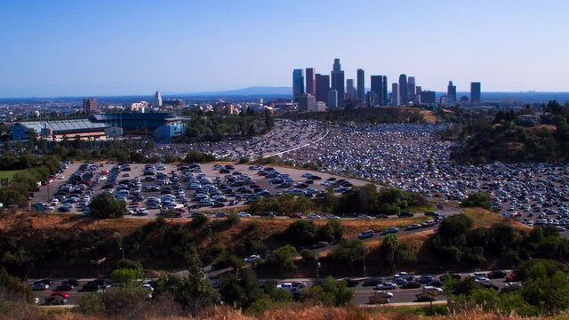 Lockdown Time Lapse Shot Of Vehicles Moving And Parked In City By Famous Dodger Stadium Against Clear Sky - Los Angeles, California