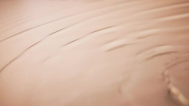 Ripples in the water in slow motion. Water surface background. Small, soft waves slowly roll over the water texture. Close up.