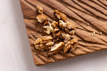 Walnut kernels on rustic board. Concept of healthy food and vegetarianism