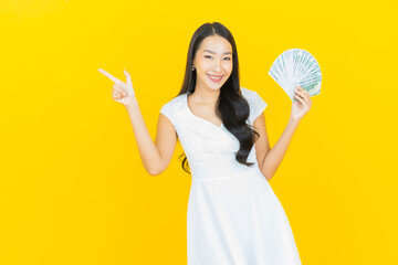 Portrait beautiful young asian woman smile with a lot of cash and money