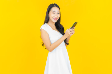 Portrait beautiful young asian woman smile with smart mobile phone