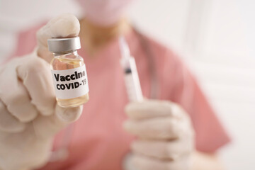 Doctor holding Coronavirus vaccine using for prevention COVID-19 infection