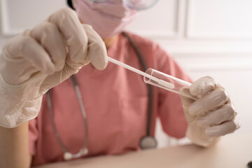 Doctor holding swab test tube for coronavirus