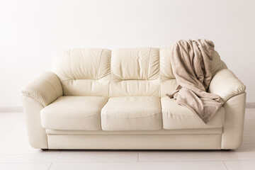 Beige sofa in room on white background. Simple minimalistic design.