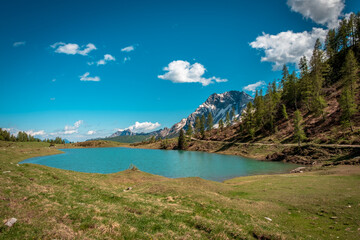 Fototapeta na wymiar Calm lake in a sunny day in the beautiful Carnic Alps, Friuli-Venezia Giulia, Italy