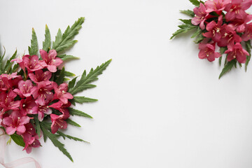 Obraz premium postcard mockup. composition of pink flowers and an envelope. white blank with place for text 