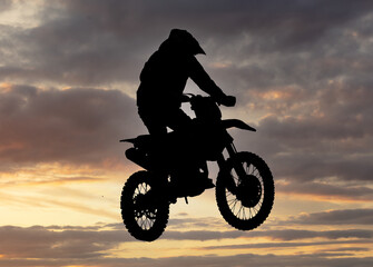 Obraz na płótnie Canvas Silhouette of a man on a motorcycle