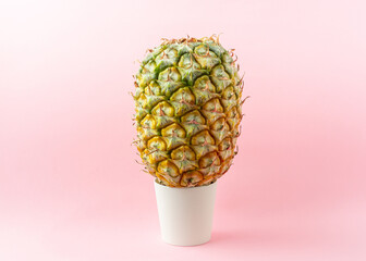 A pineapple on light pink background.