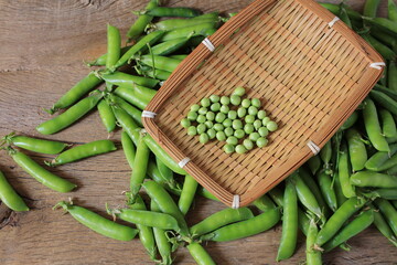 Fresh green pea pod with beans isolated on white background.  