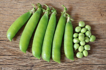 Fresh green pea pod with beans isolated on white background.  