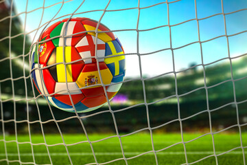 Soccer football ball with flags of european countries in the net of goal on football stadium. Euro championship 2021.