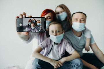 The family takes pictures of themselves. Family phone close-up on blurred background. Coronovirus. Quarantine.