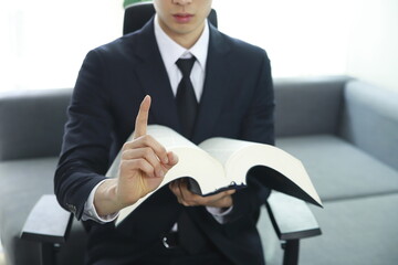 Lawyer showing number one finger with law book