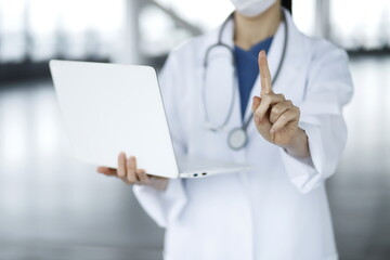 Doctor pointing finger with laptop