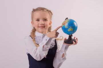 Fototapeta premium eautiful smiling blonde girl with braids schoolgirl shape globe 