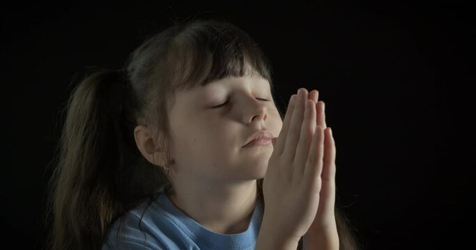 God in child prayer. A child belief in God and pray asking for help in the night.