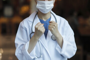 Close up of confident doctor holding fists