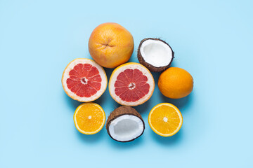 exotic fruits on a blue background. Coconut, orange, grapefruit. Top view, flat lay
