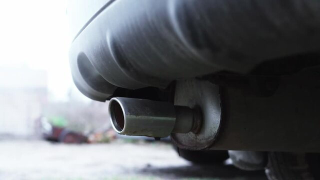 Close-up of the exhaust pipe of a muffled car