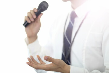 Businessman giving presentation with microphone 