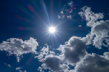 Naklejka na ściany i meble bright daylight sun in blue sky with clouds