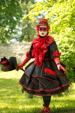Traditionally dressed Venice carnival person - woman in red andblack carnival venetian costume