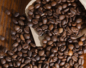 Roasted coffee beans in a paper bag. Close-up. View from above