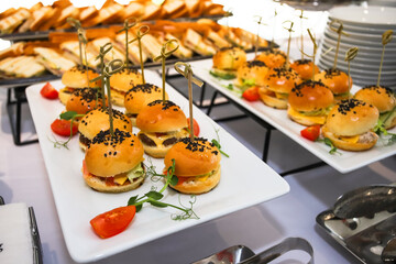Burgers with cucumber and cheese, bun with a black sesame seeds on the food court. 