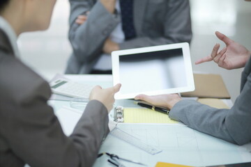 Business people working on digital tablet during meeting