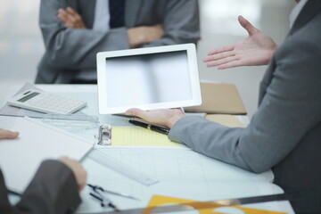 Business people using digital tablet in meeting