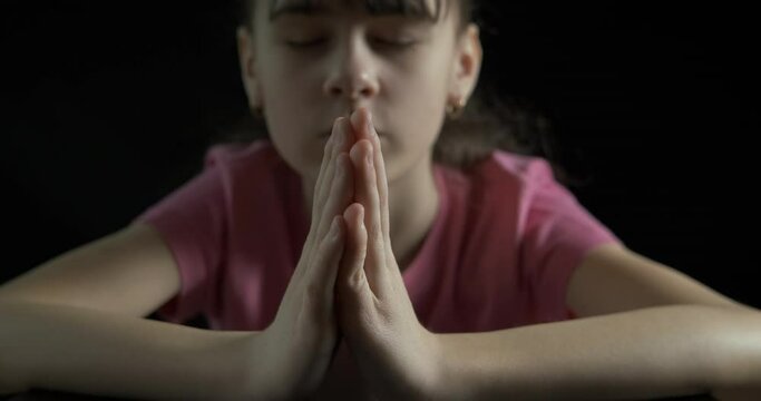 Child night with meditation. A child sits in the dark room and meditate in silence.