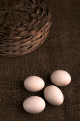 chicken eggs on the table. Farm products, natural eggs in jute background.