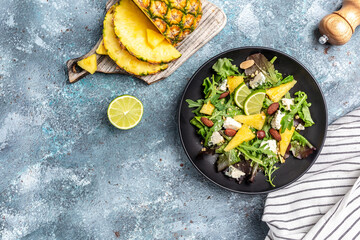 healthy salad of pineapple, blue cheese and almond. healthy and balanced food. banner, menu recipe place for text, top view
