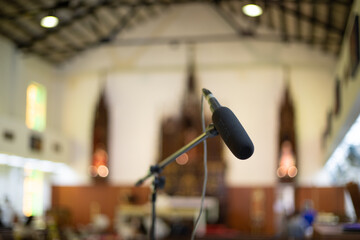microphone in blurred church background. voice of church