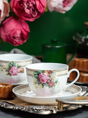 cup of tea with cookies and flowers