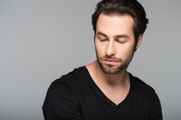 Obraz premium good-looking man in black t-shirt looking away isolated on gray.