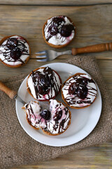 Delicious tartlets with mascarpone cheese, cherries and chocolate. Healthy dessert.
