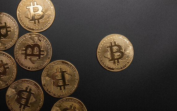 many gold bitcoin coins isolated on black background, macro photography