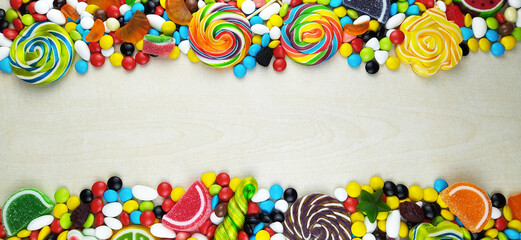 Fototapeta na wymiar colorful candies and lollipops. Top view with copy space