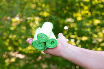 Holding bio eco plastic garbage bags in rolls