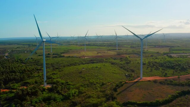 Wind turbines spinning at Los Cocos, Pedernales in Dominican Republic. Aerial rising