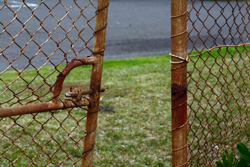 rusty and broken gate illustrating poor security