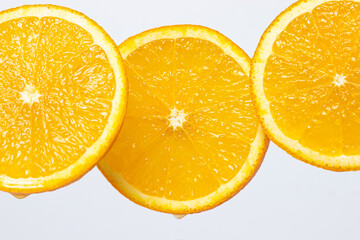 Orange slices on a white background. Ripe juicy oranges. Healthy fruit.