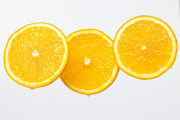 Orange slices on a white background. Ripe juicy oranges. Healthy fruit.
