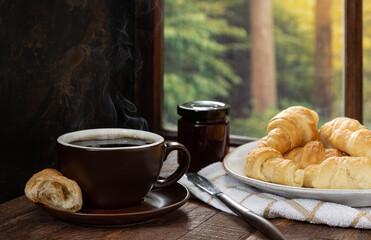 Cup of Hot Coffee and Croissants