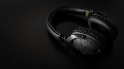 Fototapeta na wymiar New modern stereo headphones on black background