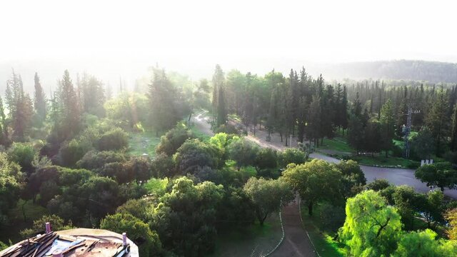 Aerial Forward Shot Of Watchtower Located In Ben Shemen Forest, Drone Flying Over Trees On Sunny Day Against Sky